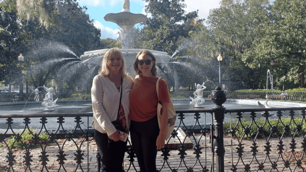 A photo of my mom and in front of a water fountain in Savannah, Georgia
